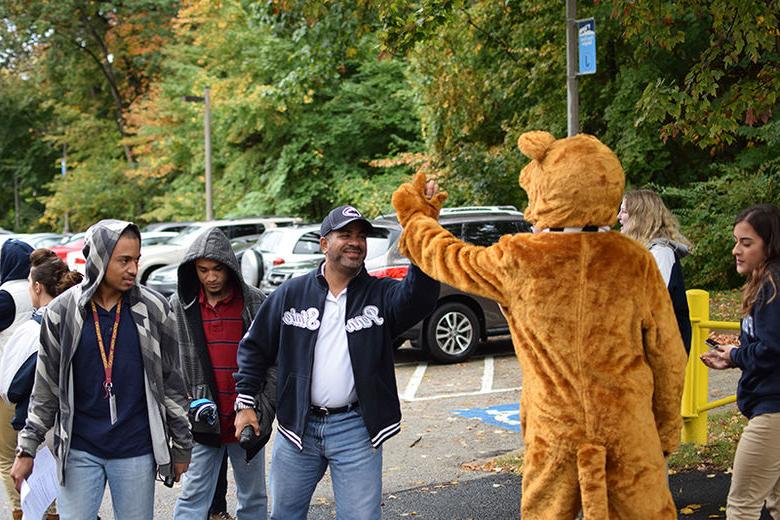 a person high fiving the Nittany Lion